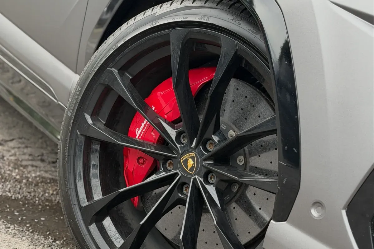 Red painted brake calipers on a Lamborghini Urus at Buff X Customization