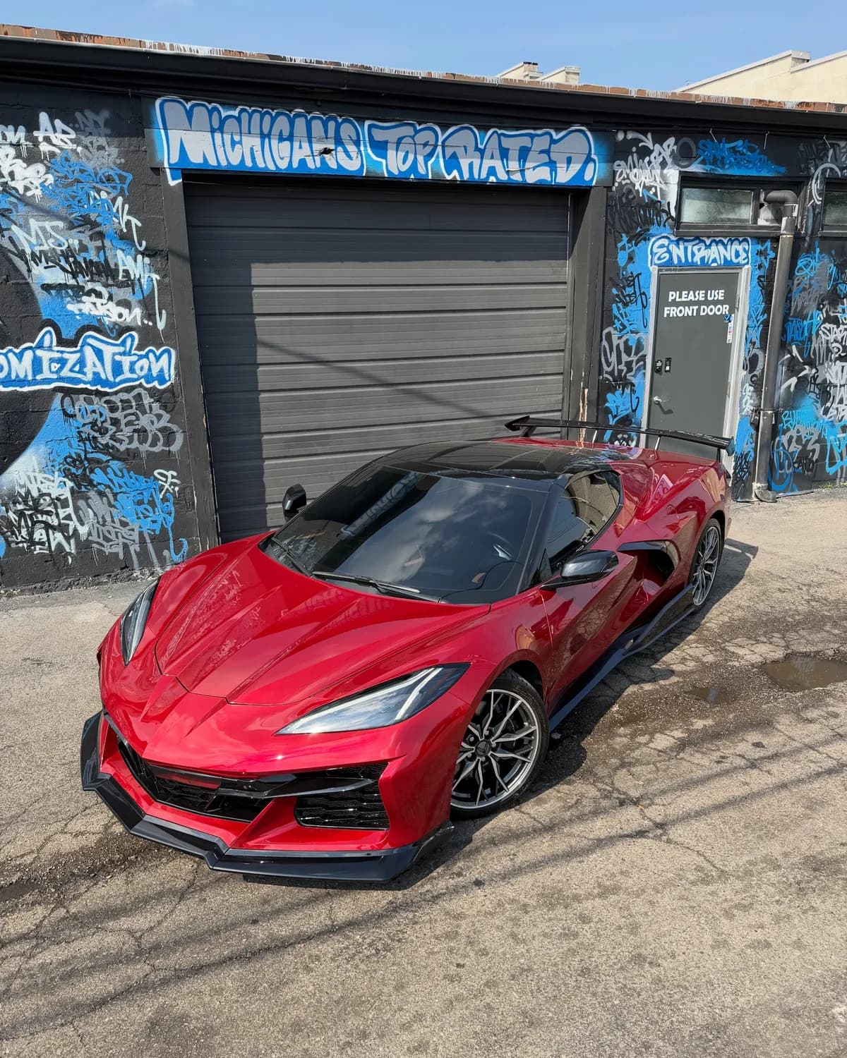 Red Corvette Z06 with a glossy ceramic coated finish outside Buff X Customization in Dearborn Heights