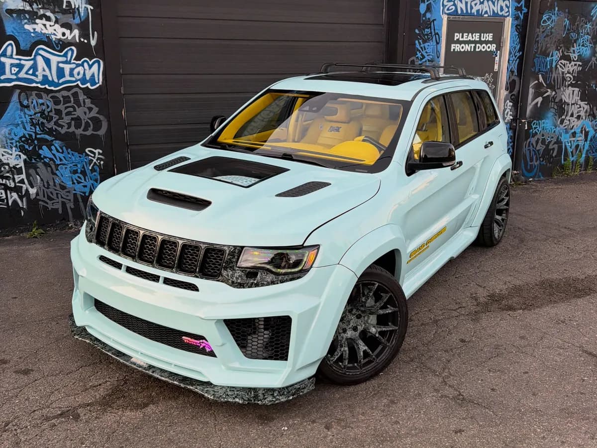 Baby blue widebody Jeep Grand Cherokee with a yellow interior at Buff X Customization