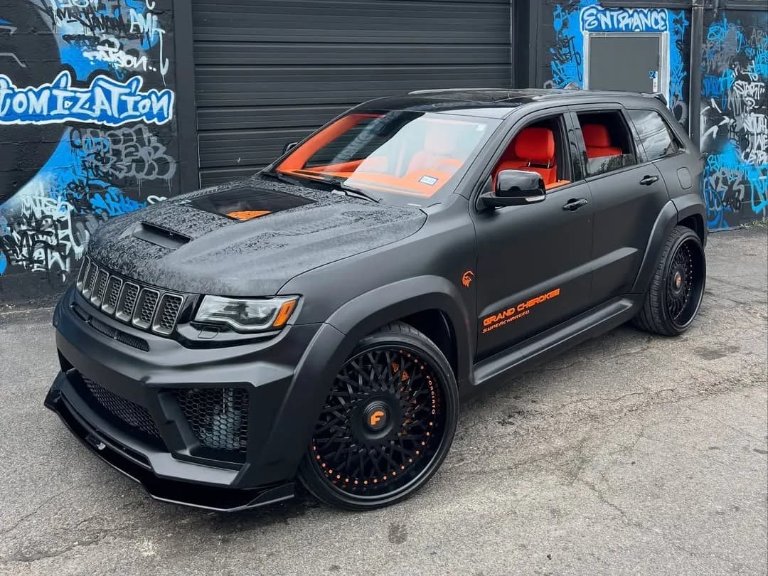 Black widebody Jeep Grand Cherokee with an orange interior at Buff X Customization