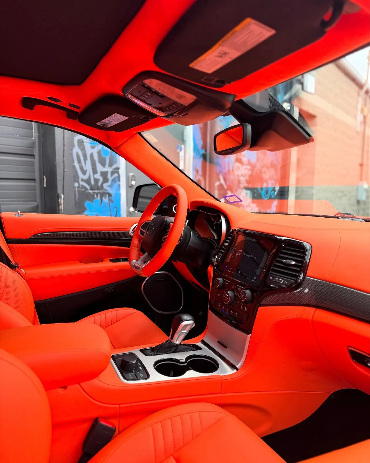 Jeep Trackhawk with a full custom orange leather interior by Buff X Customization