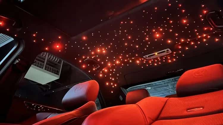 Red starlight headliner glowing inside a car cabin