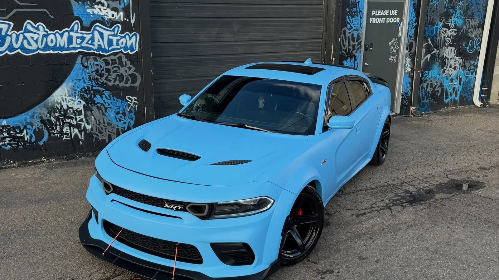 Dodge Charger wrapped in baby blue outside Buff X Customization in Dearborn Heights