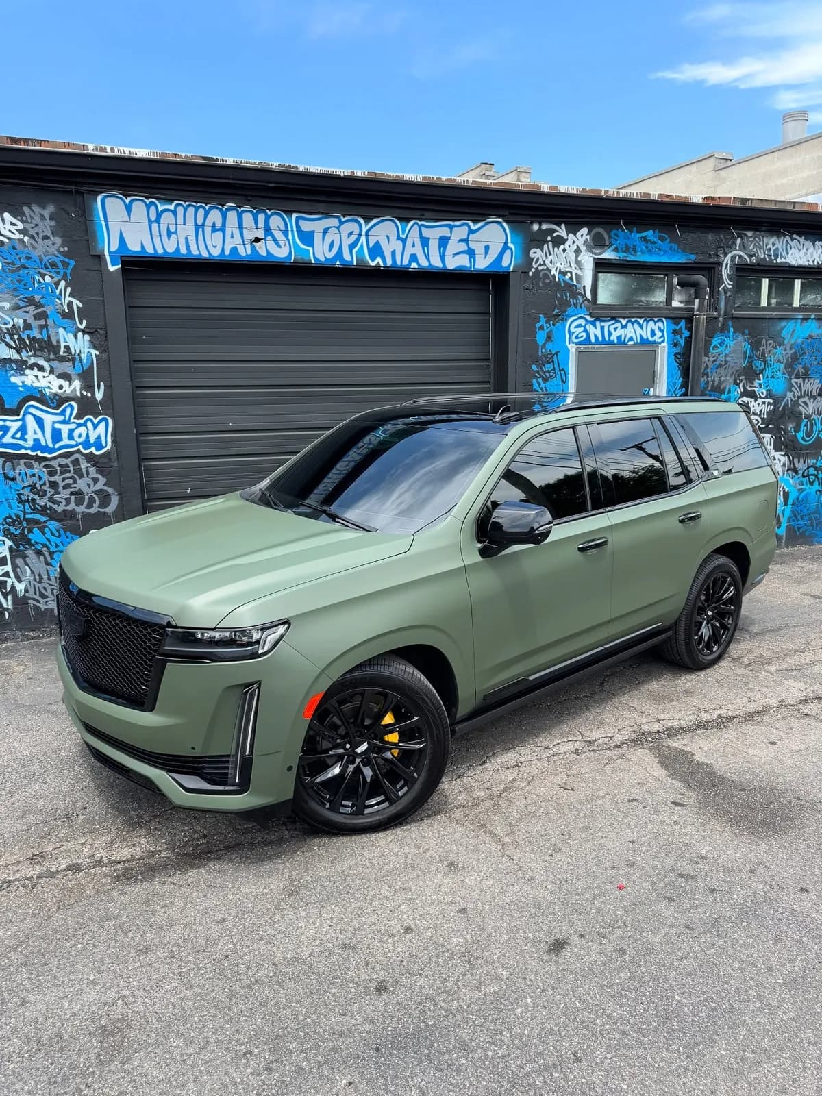 Cadillac Escalade wrapped in matte green at Buff X Customization
