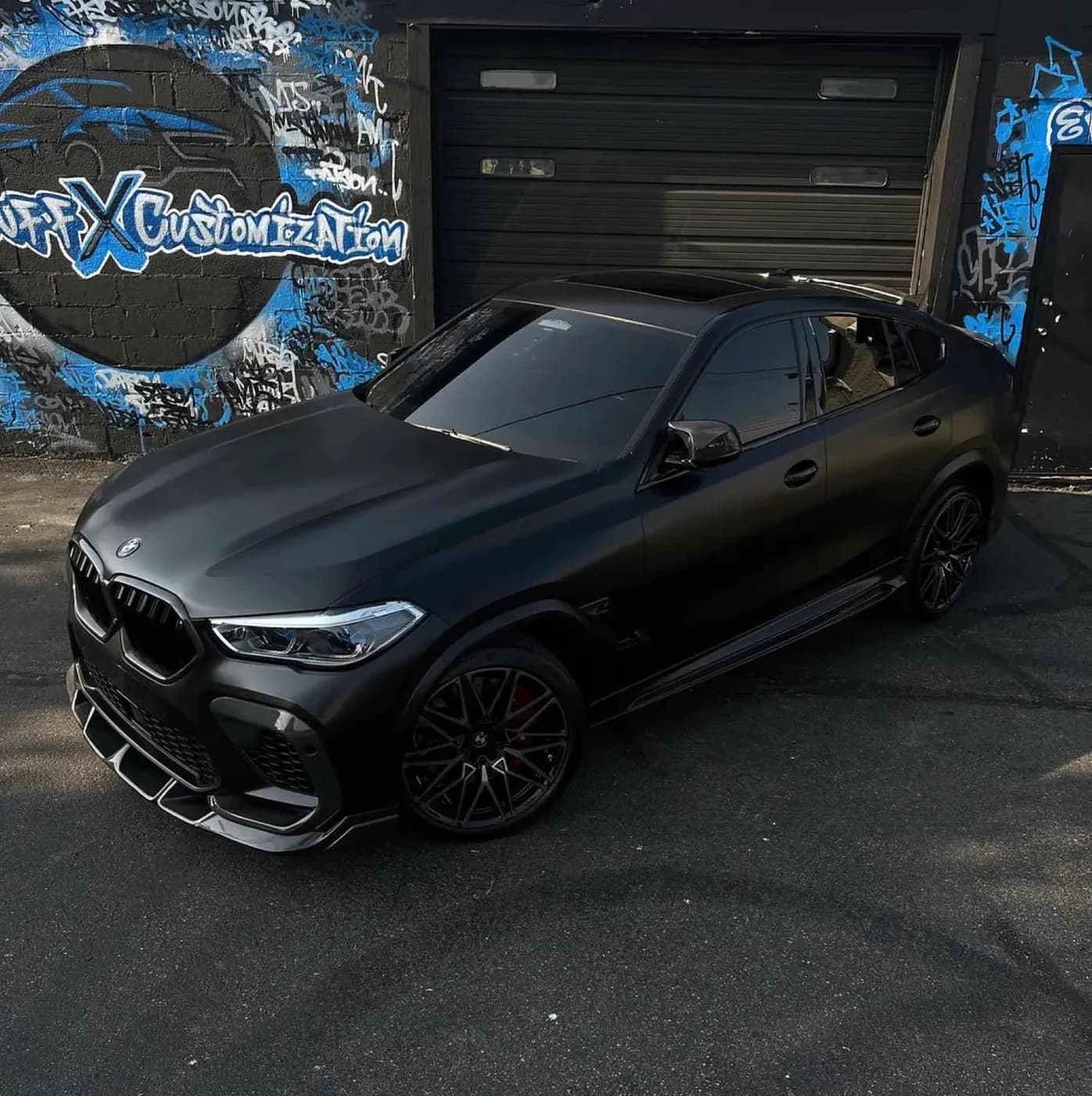 Blacked-out BMW X6 M with fresh window tint at Buff X Customization in Dearborn Heights